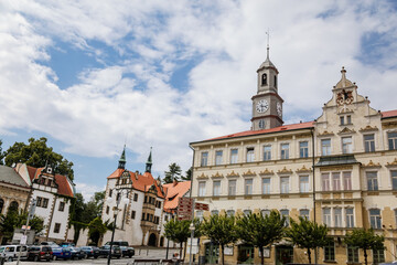Obraz premium Benesov nad Ploucnici, North Bohemia, Czech Republic, 26 June 2021: old saxoxy renaissance Morzinov Castle near Town Hall at summer sunny day, graceful towers with spiers, green trees at the street