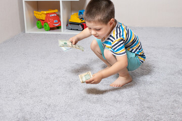 A 4-year-old child learns to count money. Financial literacy and investment education for children