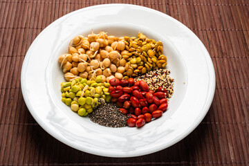 Vegan food. Sprouted grains in white dish on bamboo background