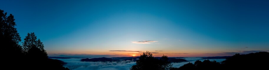 Fototapeta na wymiar bright sunrise in the mountains with blue sky
