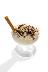 Ice cream with chocolate and wafer biscuit in glass cup isolated on white, copy space