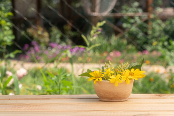 a beautiful clay vase stands on a wooden table. summer garden. field bouquet of flowers.