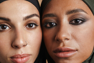 Young muslim women in hijab posing and looking at camera