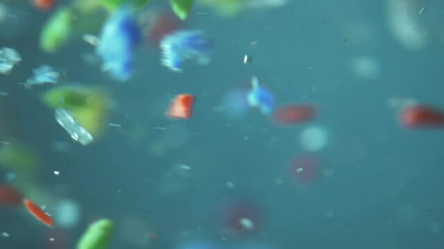 microplastics in water, tiny multicolored plastic bits. global ocean pollution - microplastic in water. recycling concept plastic background. single use plastics. microplastic pollution.