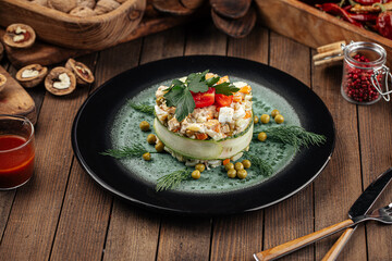 Restaurant garnished russian olivier salad on wooden background