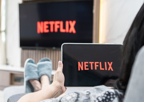 Bangkok, Thailand - July 13, 2021: Netflix App Logo On Ipad And Smart TV Television Screen Sharing In Home Living Room For Movie Watching During New Normal Lifestyle