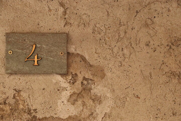 Street number sign, number four on the left side