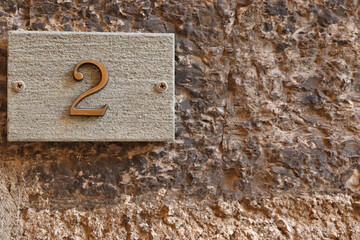 Street number sign, number two on the top left corner