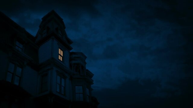 Light Turns On In Gothic Mansion At Night