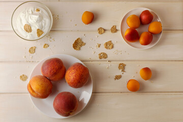 Naklejka na ściany i meble ripe peaches with yoghurt on wooden background
