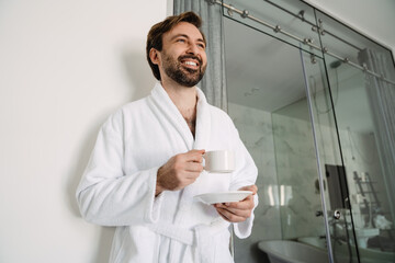 Smiling bearded white man in bathrobe