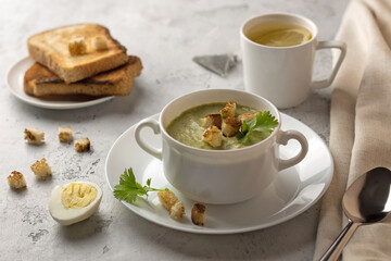 cream soup with a cup of  tea