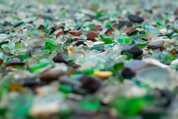 Colorful glass pebbles blanket this beach,  it was used as a garbage dump years ago, nature has tumbled the glass and polished it making it a tourist destination