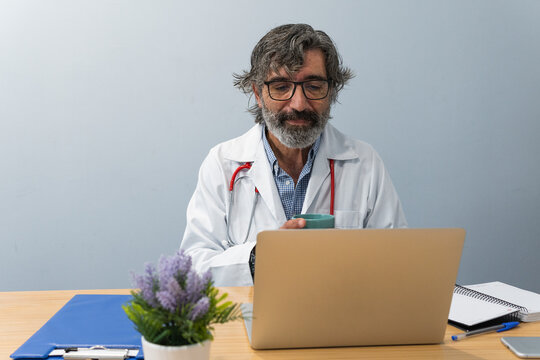 Elderly Doctor Talking To Patient On Video Chat