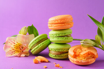 beige, green  macaroon cookies, flowers on a purple