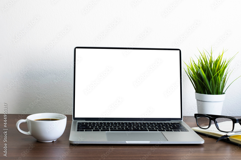 Wall mural front view of open laptop computer notebook with blank monitor white screen display on work table de