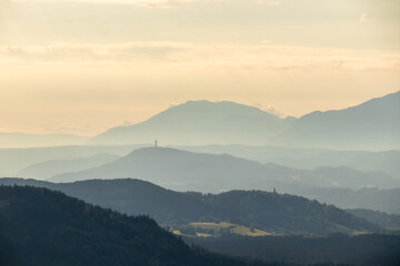 A panoramic view on endless mountain chains in Austrian Alps. The mountains are shrouded in fog....