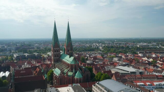 Aerial view of old town. Orbiting around Marienkirche, main parish church. Brick gothic religious building. Luebeck, Schleswig-Holstein, Germany