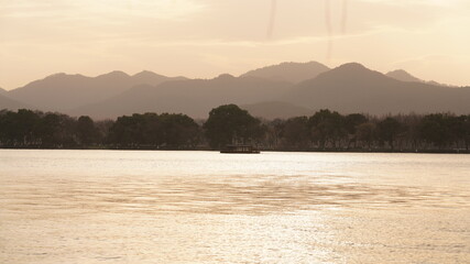 The beautiful sunset view with the lake and mountains as background in winter