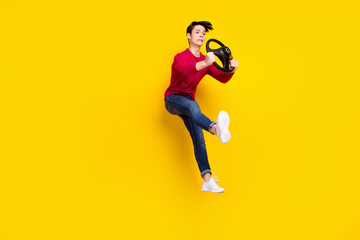 Plakat Full length photo of shocked impressed young gentleman wear red sweater jumping getting car crash isolated yellow color background