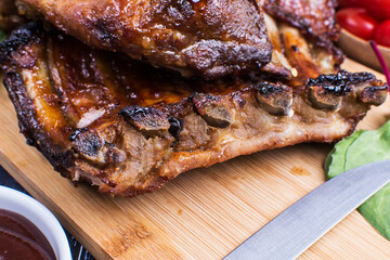 Grilled pork bbq ribs served with cherry tomatoes