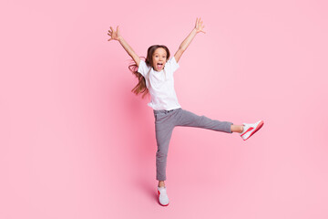 Full length body size view of pretty crazy cheerful girl jumping having fun fooling isolated over pink pastel color background