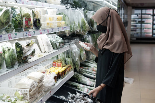 Hijab Woman Is Shopping In Supermarket Wearing Facemask During Pandemic.