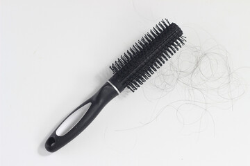 Flat Lay Photo Hair fall at white Black plastick comb, White Background
