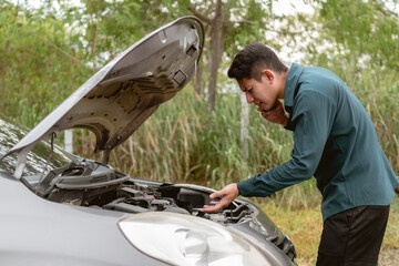 Man using phone for contact maintenance car service. Car broken concept.