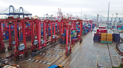 Fototapeta premium HONG KONG. February 20. Aerial view of huge industrial port with containers and huge ship.