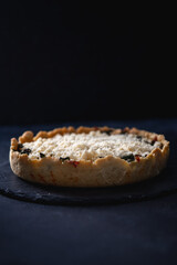 Millet quiche with spinach, salmon, broccoli and ricotta on dark wooden table. Homemade 
vegetarian cake. Copy space for text. Fresh pie with soft cheese. Healthy food. French cuisine