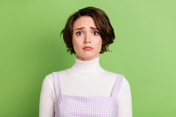 Photo of young woman unhappy sad upset negative moody sorrow fail isolated over green color...