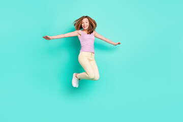 Fototapeta na wymiar Full length photo of lovely brown teen girl jump wear top pants isolated on teal color background
