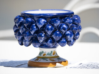 sicilian ceramic cup of caltagirone town on a table