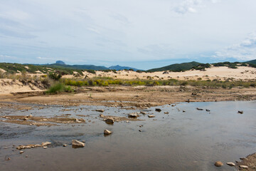 sand dunes on the beach and creek