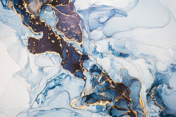 Luxury abstract fluid art painting in alcohol ink technique, mixture of dark blue, gray and gold paints. Imitation of marble stone cut, glowing golden veins. Tender and dreamy design. - 444964156