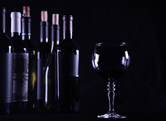wine glass with bottle and black background