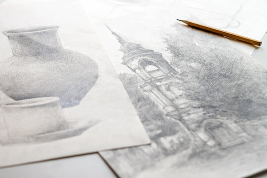 Drawings made in pencil are on the table.