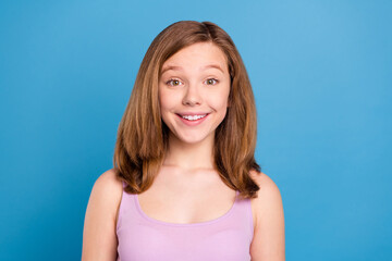 Photo of funny brown hairdo teen girl wear violet top isolated on blue color background