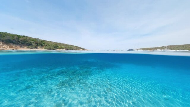 Split-shot, over-under shot. Stunning view of half underwater half sky with a beautiful and turquoise water. Liscia Ruja, Sardinia, Italy.