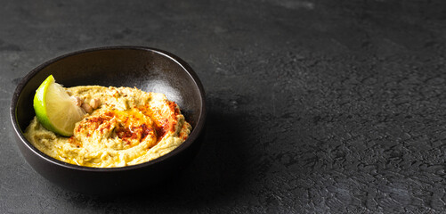 Hummus bowl with red smoked paprika and lime. Healthy snack concept.Banner with copyspace