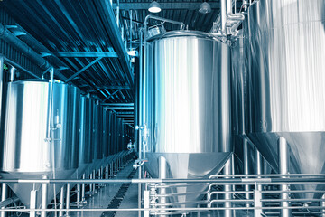 Private microbrewery. Modern beer plant with brewering kettles, tubes and tanks made of stainless steel