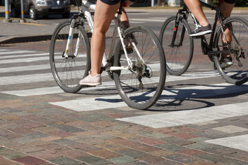 Fototapeta na wymiar cyclists cross the street at a pedestrian crossing