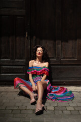 Naklejka premium Beautiful woman in the flowers dress in summer city