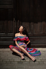 Beautiful woman in the flowers dress in summer city