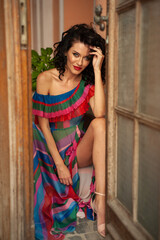 Fototapeta premium Attractive sensual woman wearing summer dress in the old city