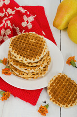 Waffles on a white plate with pears