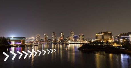 Fototapeta na wymiar White chevron pattern design against view of cityscape at night
