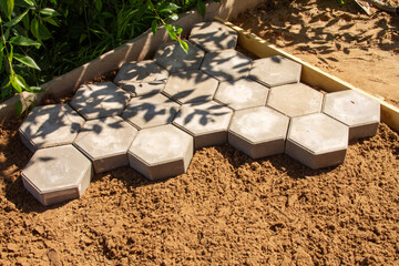 laying of hexagonal construction tiles of gray color close-up