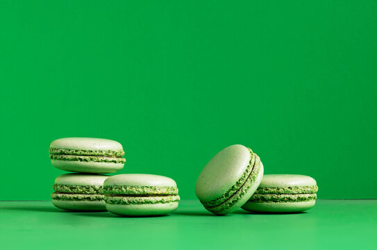 Composition with french macarons on green background.